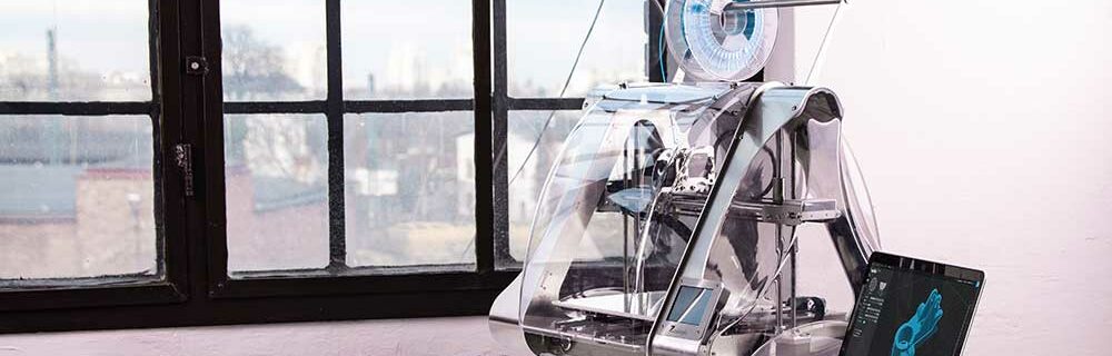 3D Printer on a desk next to a laptop