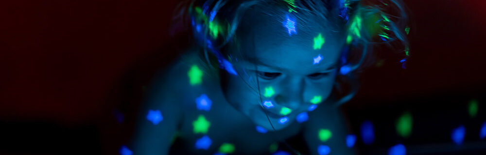 Toddler playing with star lights