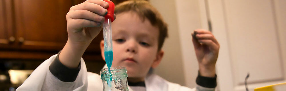 Kid playing with a science ki