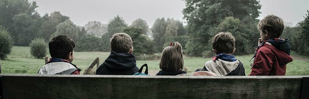 Kids hanging out together on a bench