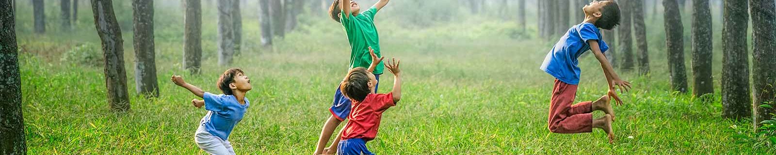 4 boys having fun jumping in the air