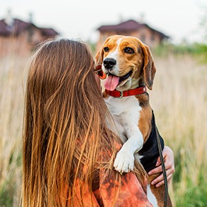 Snuggling with dog outdoors
