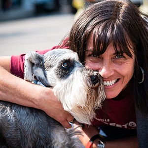 Lady hugging her dog