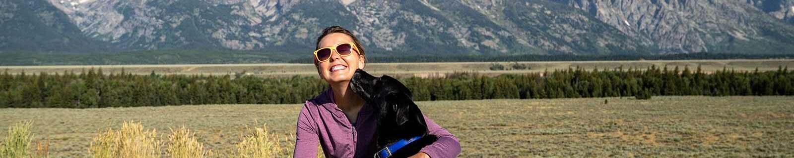 Woman in mountains with dog