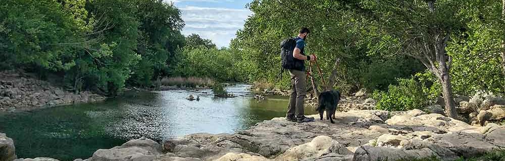 hiking with a dog at barton creek in austin texas